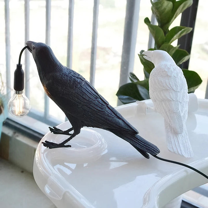 A photo of the Raven Lamp in a cozy bedroom, providing soothing and relaxing lighting.