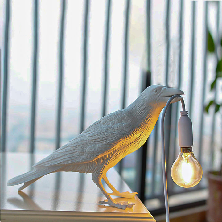 A photo of the Raven Lamp on a desk, providing ample lighting for work or study.