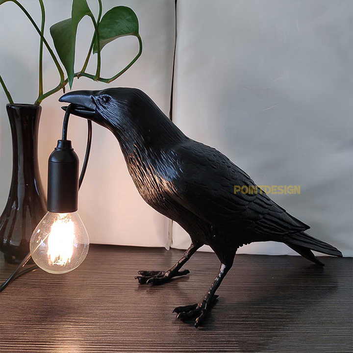 A photo of the Raven Lamp in a reading book, providing cozy and comfortable lighting.