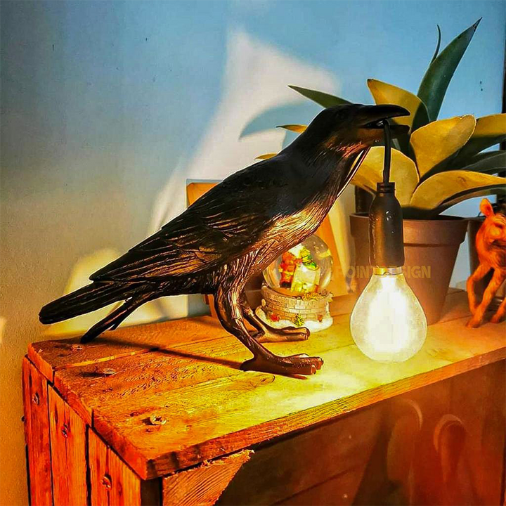 The Raven Lamp on a Wooden Table in a Cozy Living Room Setting