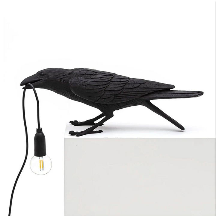 A photo of the Raven Lamp in a cozy study, providing a relaxing and inviting atmosphere.